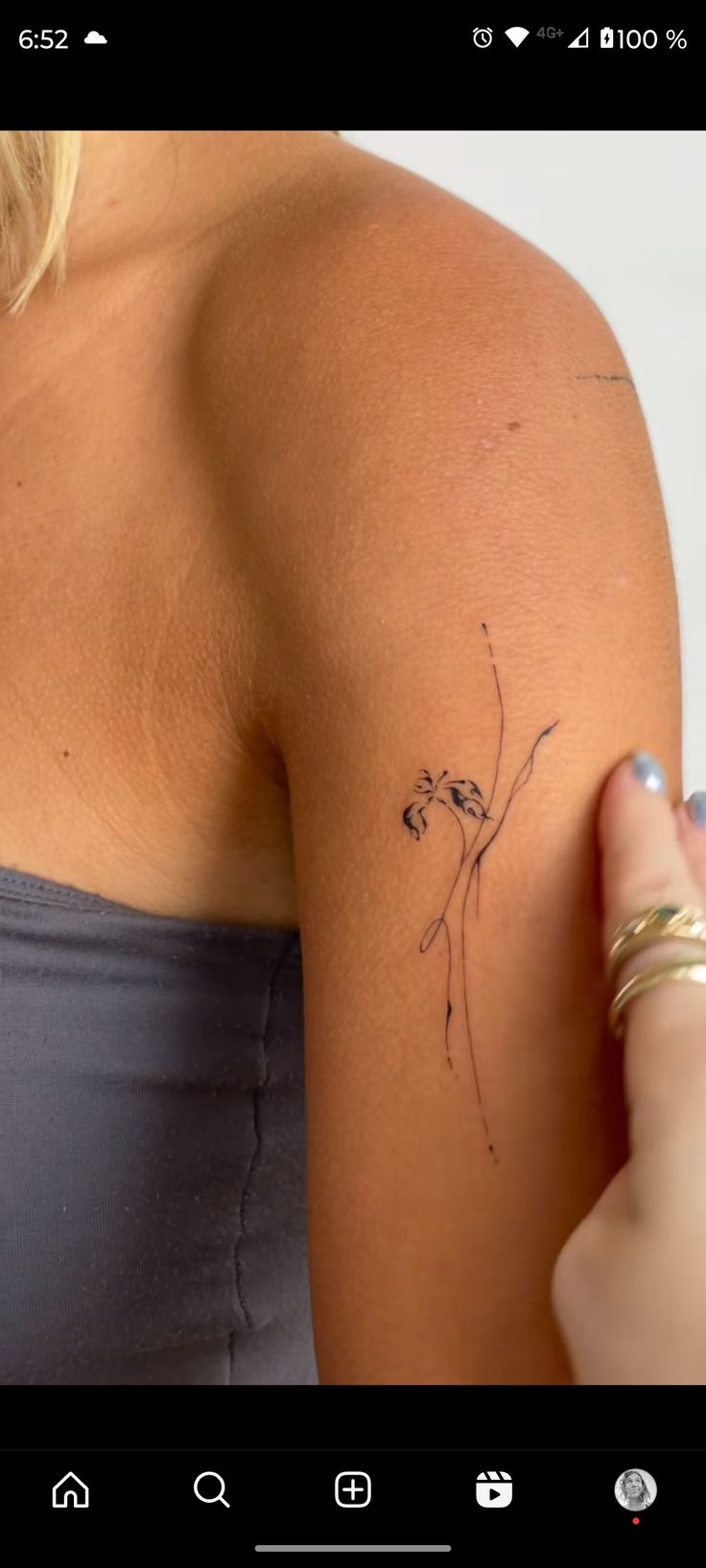 a woman with a small tattoo on her arm