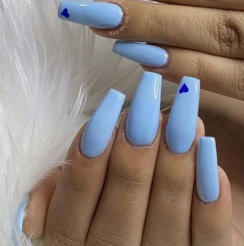 a woman's hand with blue nail polish on it