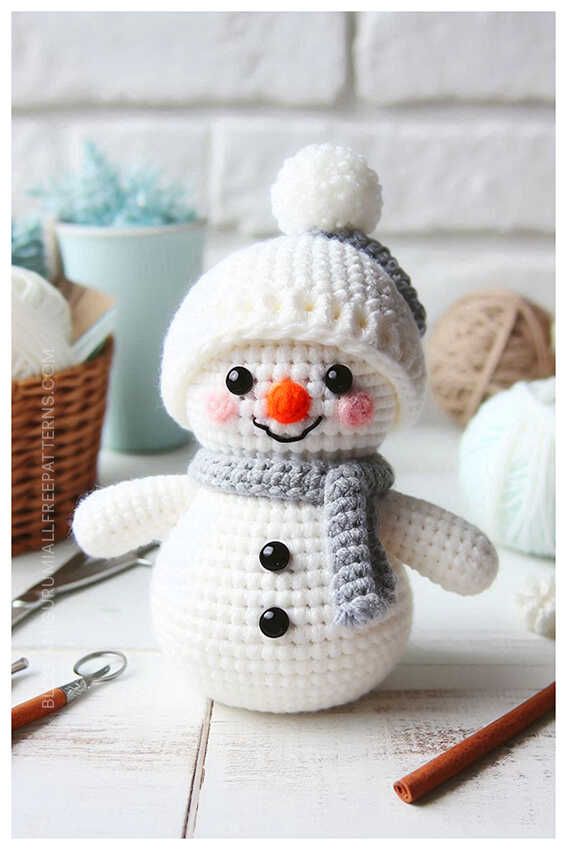 a crocheted snowman with a knitted hat and scarf on it's head