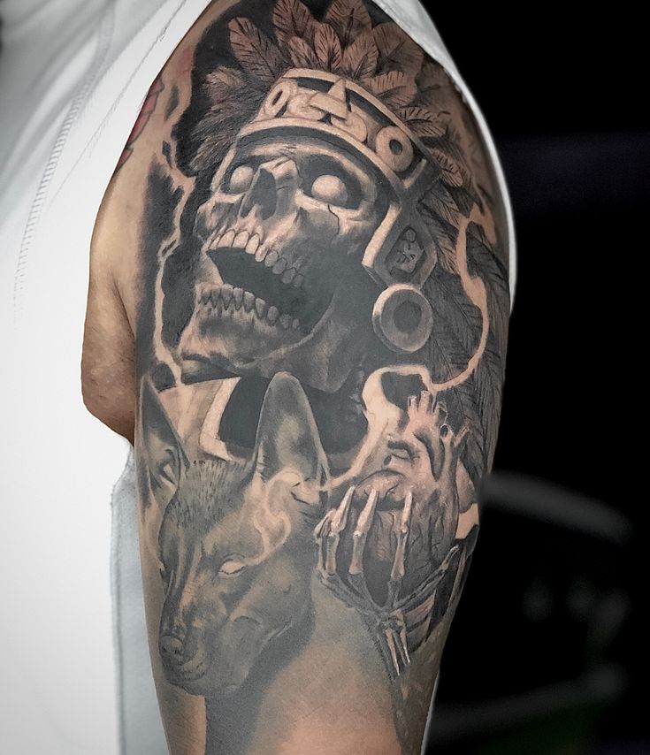 a man with a skull and wolf tattoo on his arm