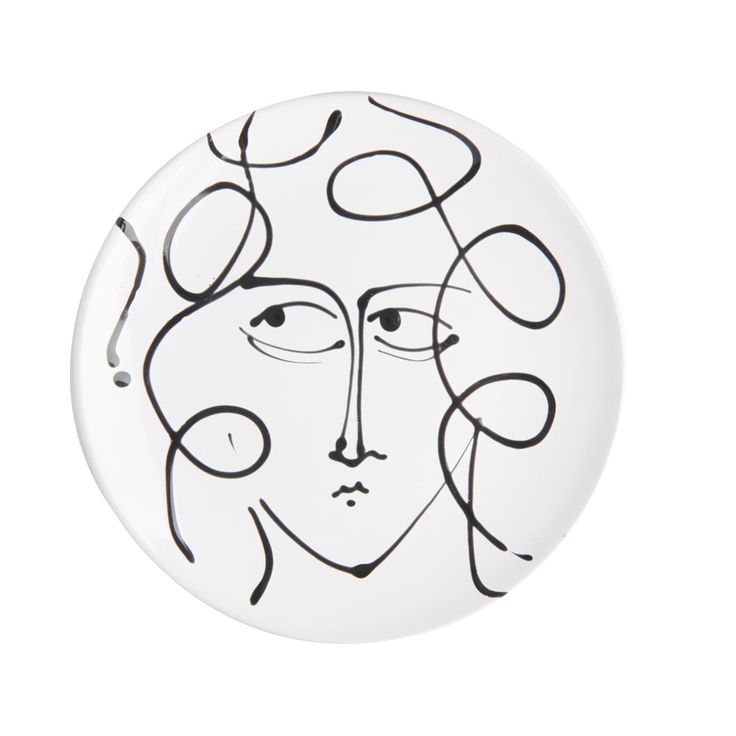 a white plate with a black and white drawing of a woman's face on it