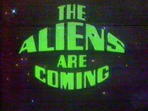 the aliens are coming sign is lit up in green and black colors on a dark background