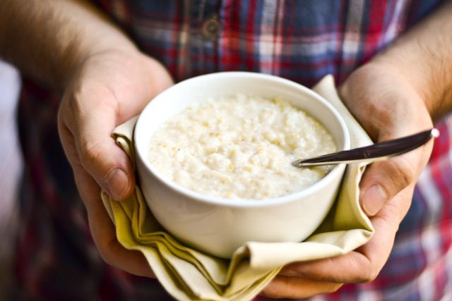 a person holding a bowl of oatmeal in their hands