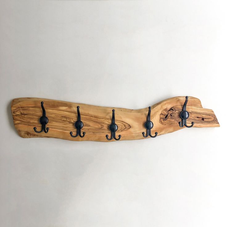 a coat rack made out of wood with hooks