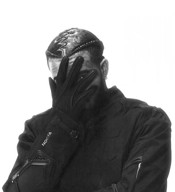 a man with his hands on his face and gloves covering his face, in black and white