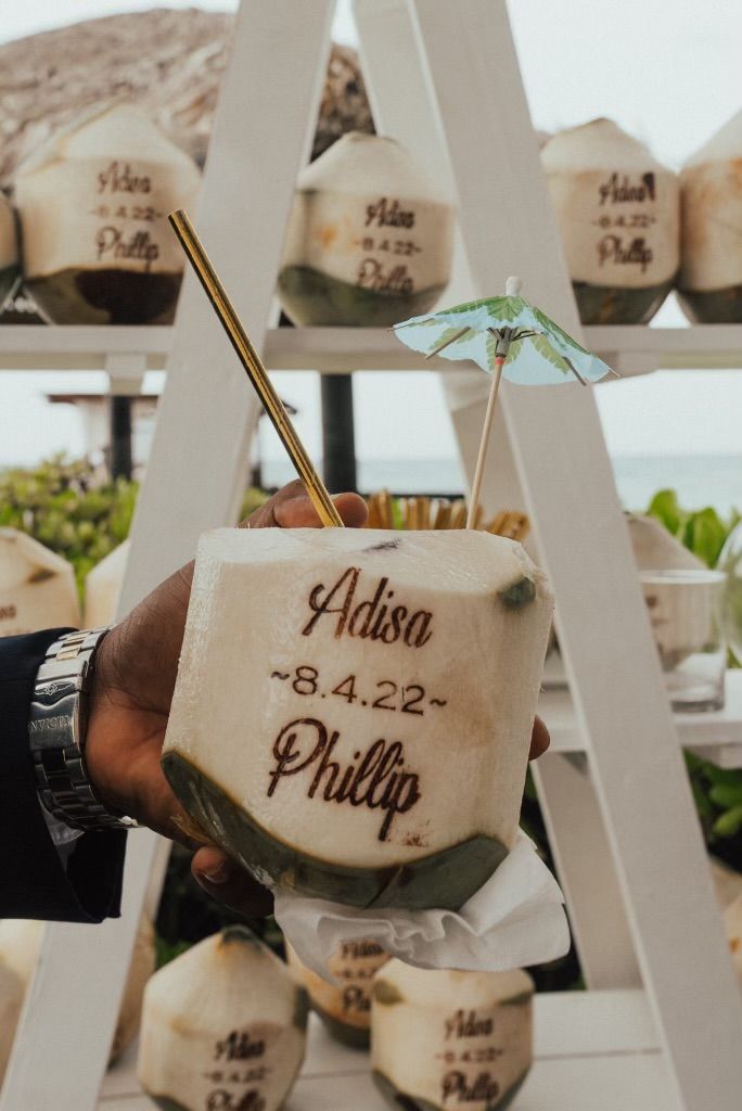 a hand holding a cup with an umbrella on it