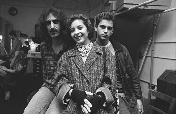 black and white photograph of three people in a room