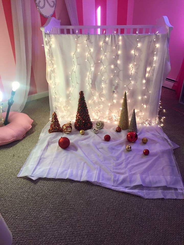 a baby crib decorated with christmas trees and ornaments