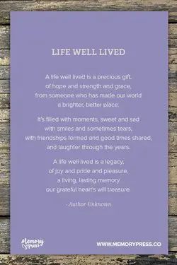 a purple card with the words life well lived written in white ink on wood planks