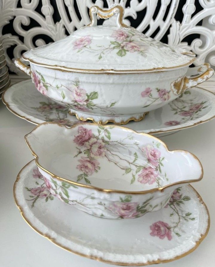 three white dishes with pink flowers and gold trimmings on the sides, sitting next to each other