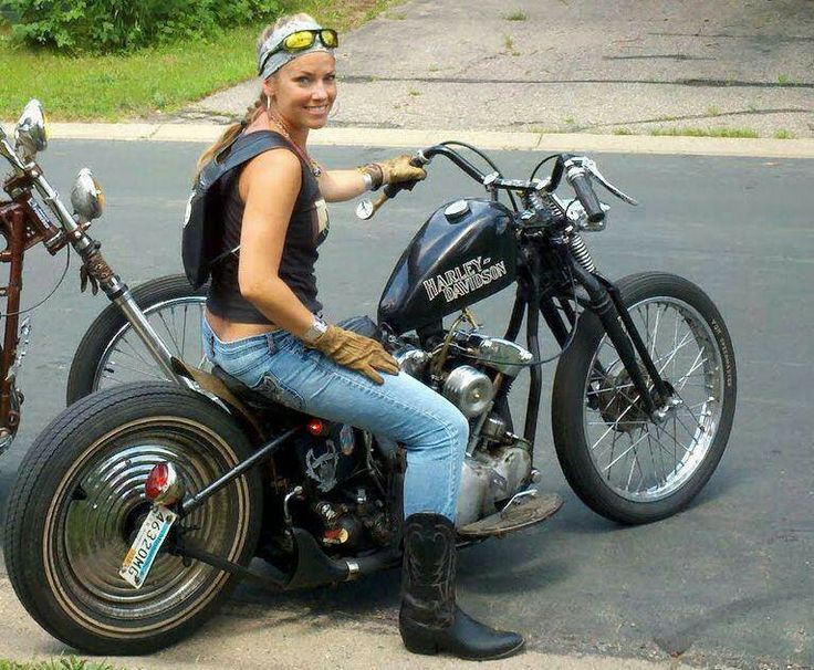 a woman sitting on top of a motorcycle