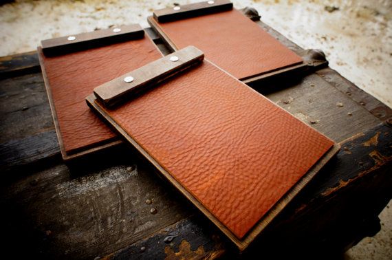 three leather notebooks sitting on top of each other