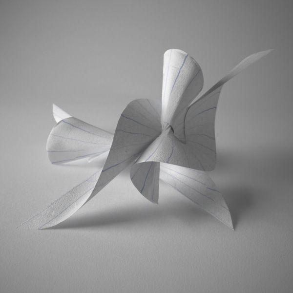 an origami bird is shown on a gray surface with white lines in the middle