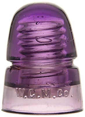 a close up of a purple glass object with the word w c m o on it