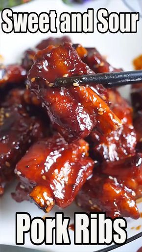 sweet and sour pork ribs on a white plate with chopsticks in the middle