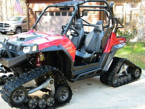 a red and black atv parked in front of a house