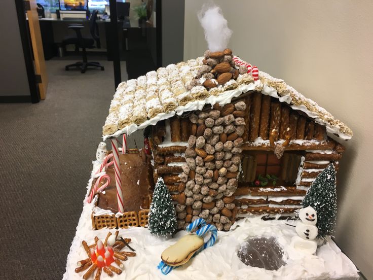 a gingerbread house made to look like it's been built in the snow