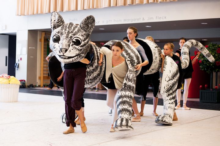 a group of people walking down a street with animal costumes on