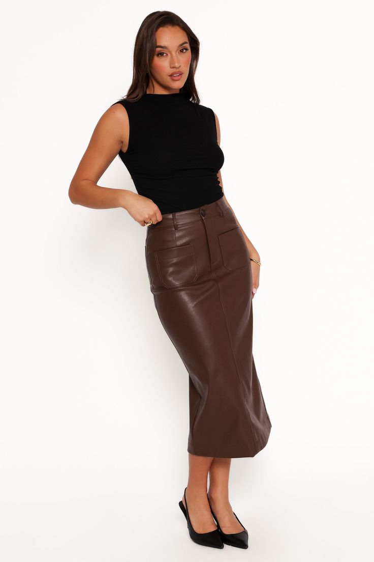 D  ETAILS   The midi length strikes the perfect balance between chic and versatile, making it suitable for both daytime outings and evening events. With belt loops and a front zip complemented by a functional button closure, this skirt ensures that you look as polished as you feel.   faux leather skirt  midi length  belt loops  front zip with functional button close  functional front and back pockets  back split detail  unlined    material - 100% PU    SIZING    studio model is 5' 7" and wears a Leather Skirt Midi, Skirt Midi, Faux Leather Skirt, Colby, Cold Hands, S Models, Midi Length, Leather Skirt, Midi Skirt