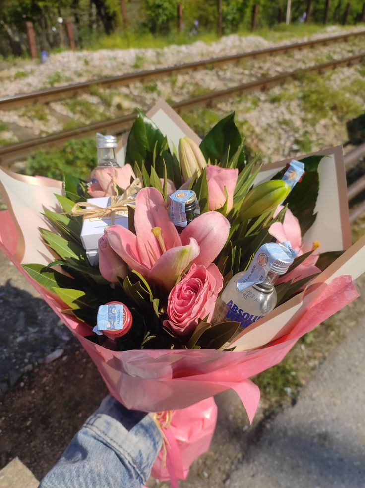 a bouquet of pink flowers sitting on top of a train track