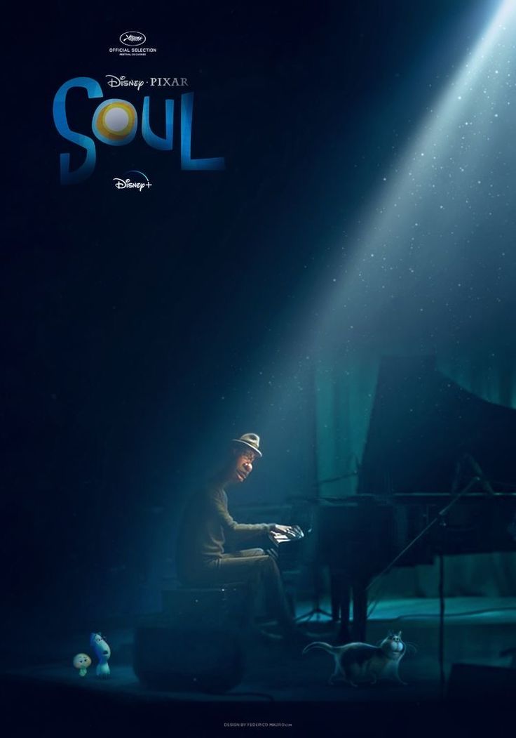 a man sitting at a piano in front of a spotlight