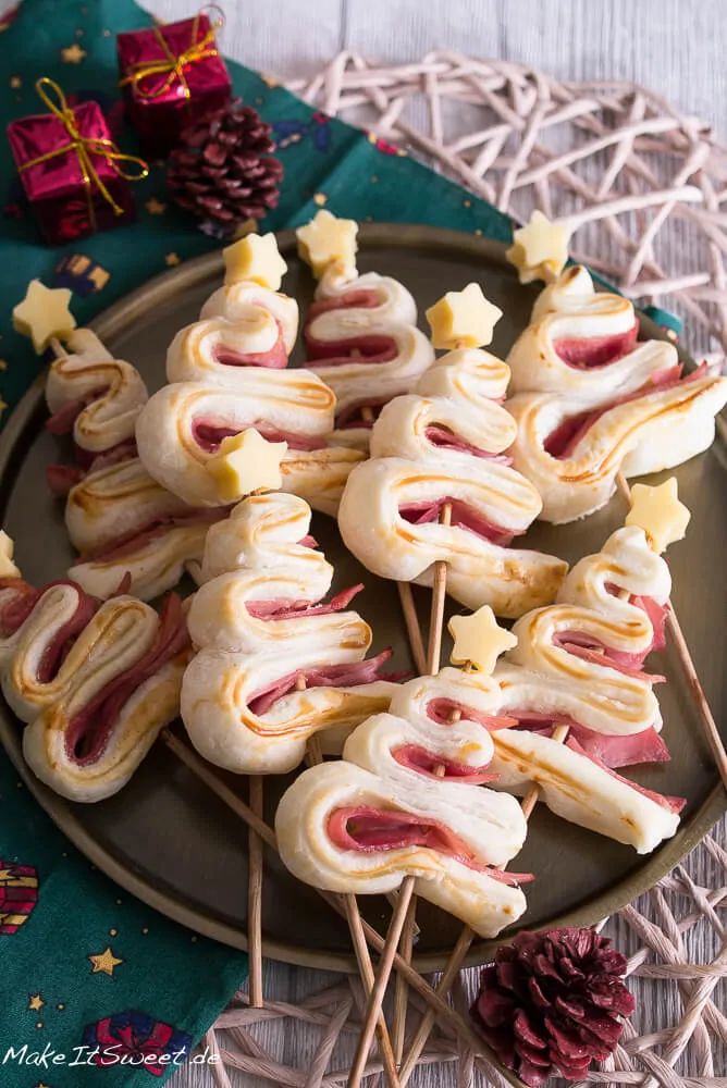 ham and cheese skewers on a plate with pine cones