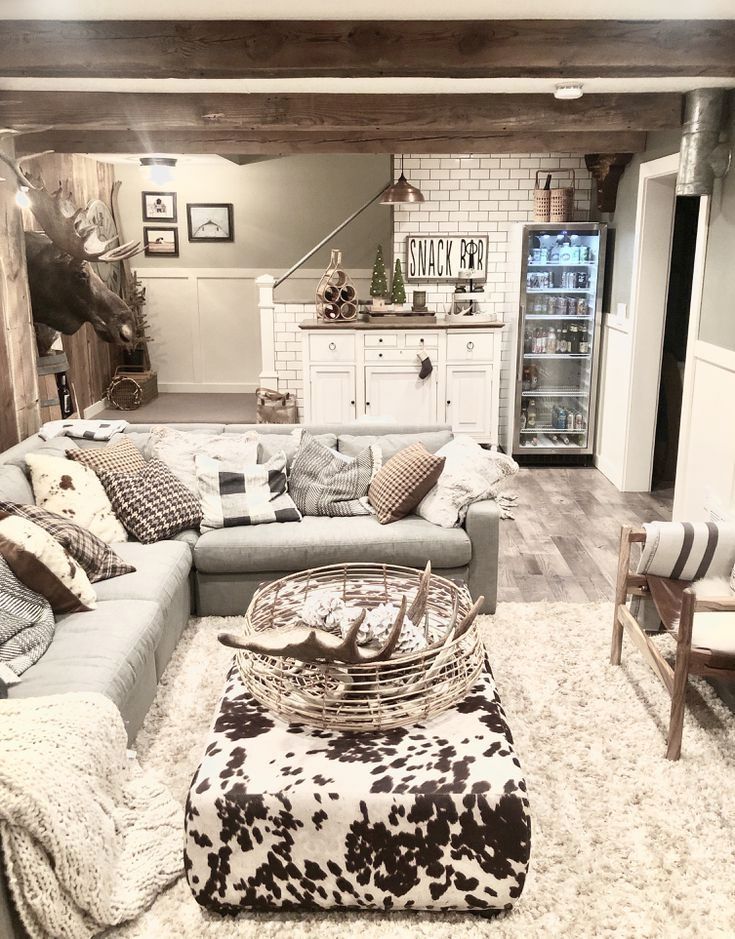 a living room filled with furniture and a cow print rug on top of a wooden floor