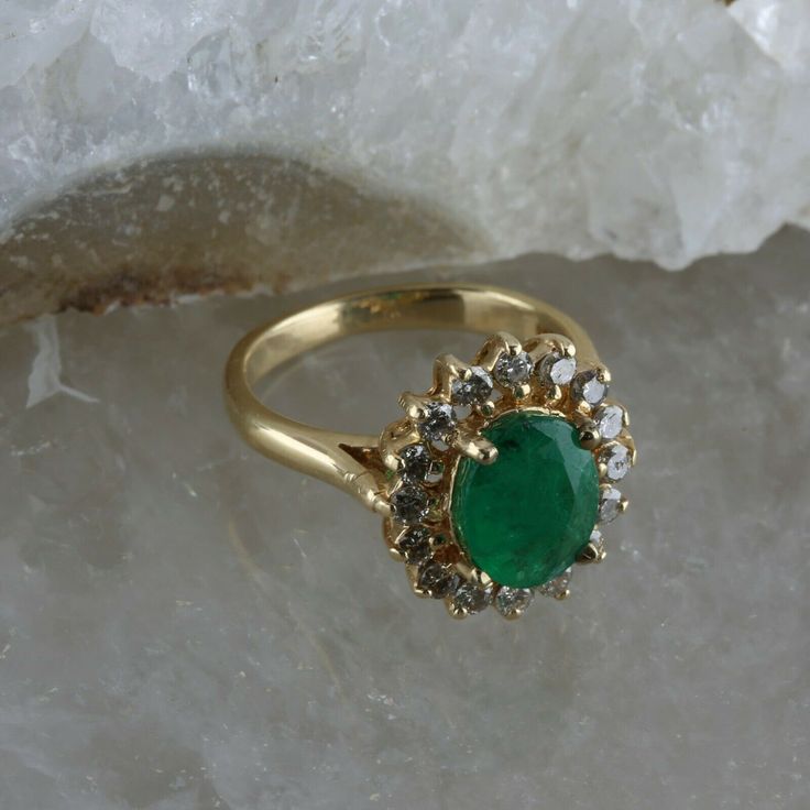 Vintage 14K Yellow Gold Oval Emerald and Diamond Halo Ring, 1.53ct emerald set high 5/16 inches on ring, basket setting, oval emerald 1.53 ct, 9x7mm, .56 ct round diamonds halo (16 total), .5 inches across, Ring size 4.75, Circa 1960, 4 grams. Stock # BB256R04 Most rings are sizable for a small fee. If the ring you are considering is the incorrect size contact us for a quote. This listing contains photographs of the actual item you will receive. Our items are in excellent condition with little o Oval Gold Emerald Ring With Halo Setting, Oval Emerald Ring In Yellow Gold With Halo Setting, Vintage Oval Emerald Cluster Ring, Formal Green Oval Cluster Ring, Formal Oval Green Cluster Ring, Gold Oval Emerald Ring With Prong Setting, Vintage Oval Emerald Ring With Halo Setting, Vintage Oval Emerald Ring With Prong Setting, Oval Green Cluster Ring In 14k Gold