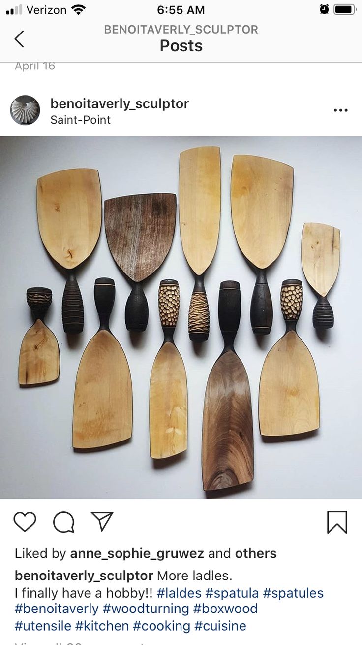 a bunch of wooden spoons and spatulas sitting on top of each other