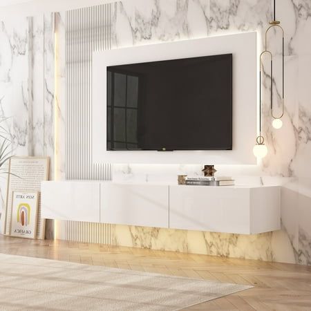 a tv mounted on the wall in a living room with marble walls and flooring