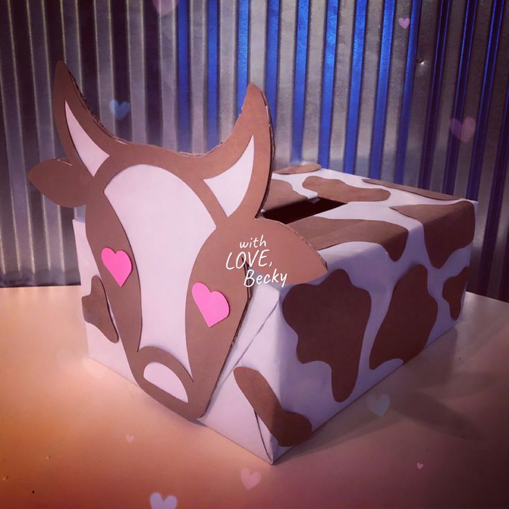 a box that has some kind of animal design on the inside of it, and is decorated with pink hearts