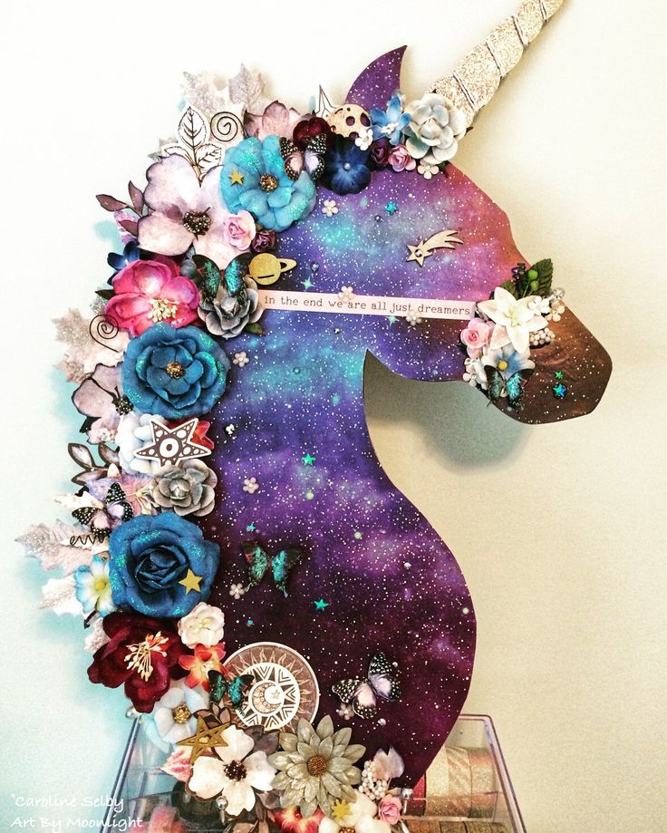 a unicorn head made out of flowers and other things