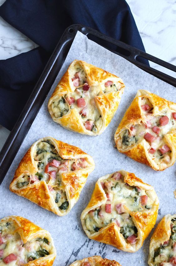 several small pastries on a baking sheet