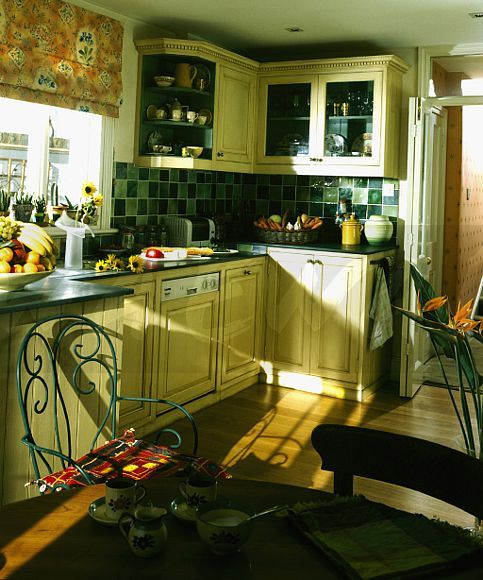 the kitchen is clean and ready to be used for cooking or baking, with sun shining through the windows