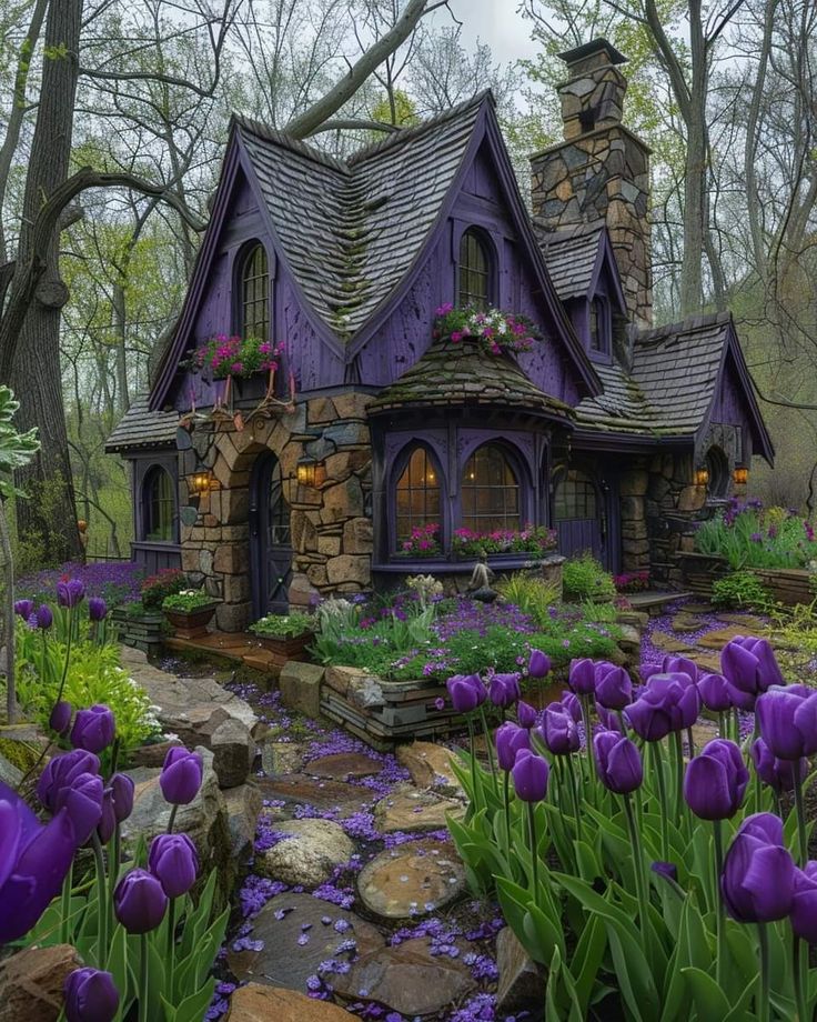 a purple house surrounded by flowers and trees