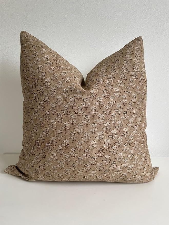 a brown pillow sitting on top of a white table