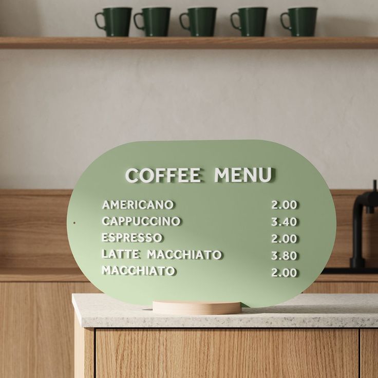 there is a sign that says coffee menu on the counter in front of some cups