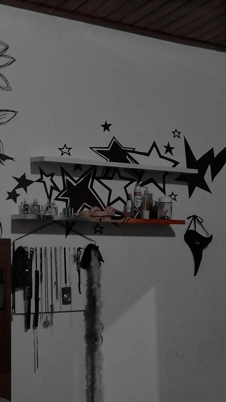 the wall is decorated with black and white paper cutout stars, birds, and kites