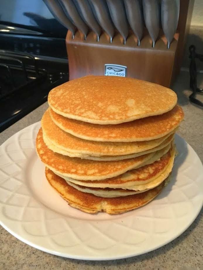 a stack of pancakes sitting on top of a white plate