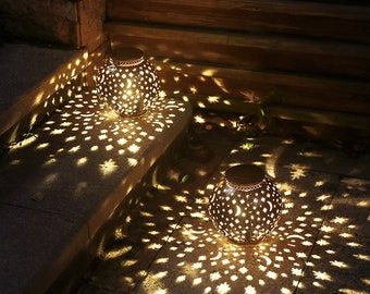 two decorative lights are sitting on the ground