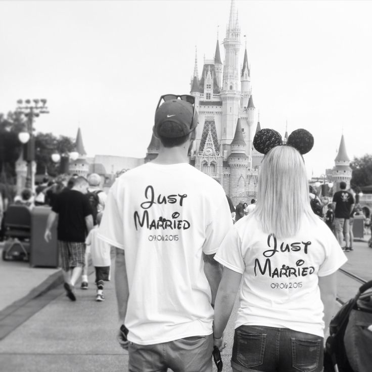 two people wearing shirts that say just married and just married in front of a castle