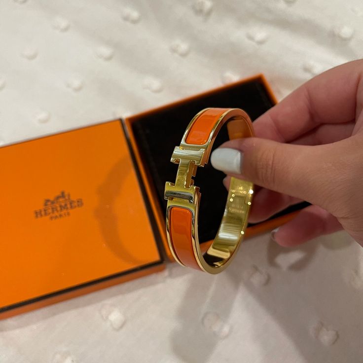 Almost New Herms Bracelet. Orange And Gold So Beautiful. Only Worn A Few Times Modern Orange Bangle Bracelets, Elegant Orange Bracelet For Gift, Elegant Orange Bangle Bracelet, Elegant Orange Bangle Jewelry, Orange Bracelet For Formal Occasions, Formal Orange Bracelet Jewelry, Formal Orange Bracelet, Hermes Bracelet, Hermes Jewelry