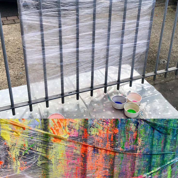 two bowls are sitting on top of a table covered with plastic wrap and some paint