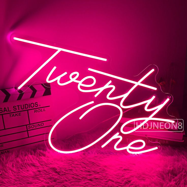 a neon sign that says twenty one in front of a pink background with the words twenty one on it