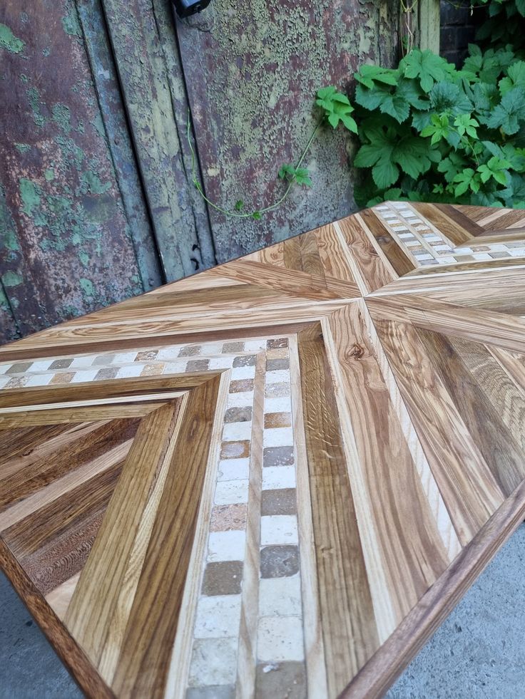 a wooden table that has been made out of wood and tiles on top of it