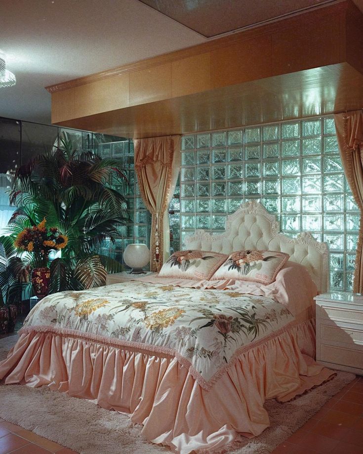 a large bed sitting next to a window in a bedroom