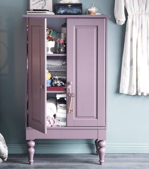 an armoire in a room with blue walls