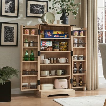 a wooden bookcase filled with lots of books and coffee cups on top of a hard wood floor