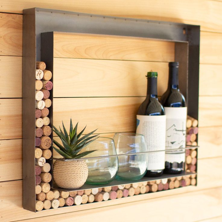 a wooden shelf with wine bottles and glasses on it