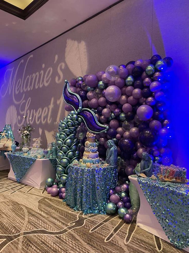 the table is set up with purple and blue decorations